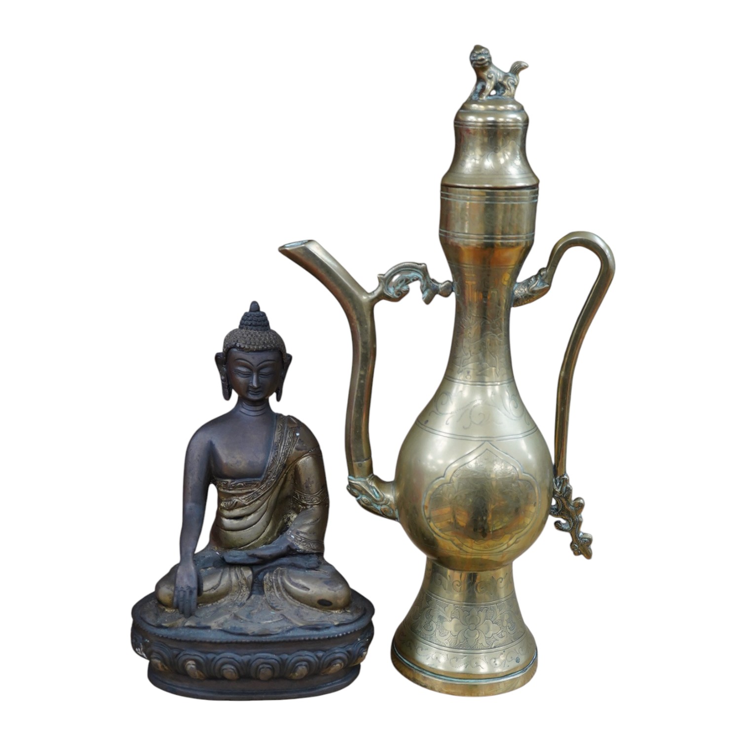 A South East Asian bronze Buddha and an engraved brass wine ewer, 39cm high. Condition - good